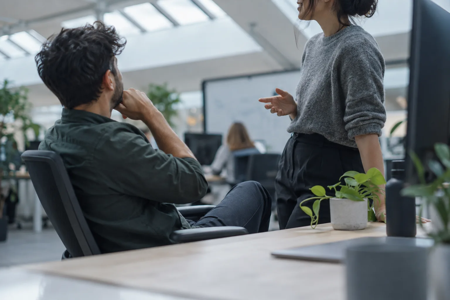 Employee at a life sciences office desk asking a question through one conversational AI interface